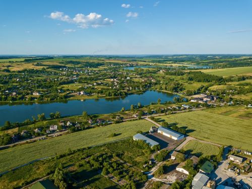 Aerial view over of a rural landscape near a lake. Concept image for blog: What Property Owners Should Know About Eminent Domain Laws in North Carolina.